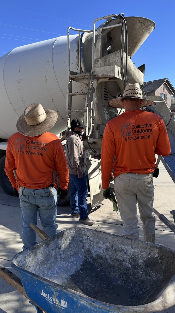 TCO crew in orange company shirts on a job site beside a concrete truck