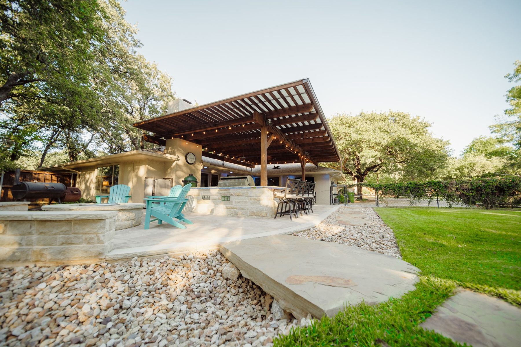 Curved flagstone patio and seat wall leading to a timber pavilion, Arlington