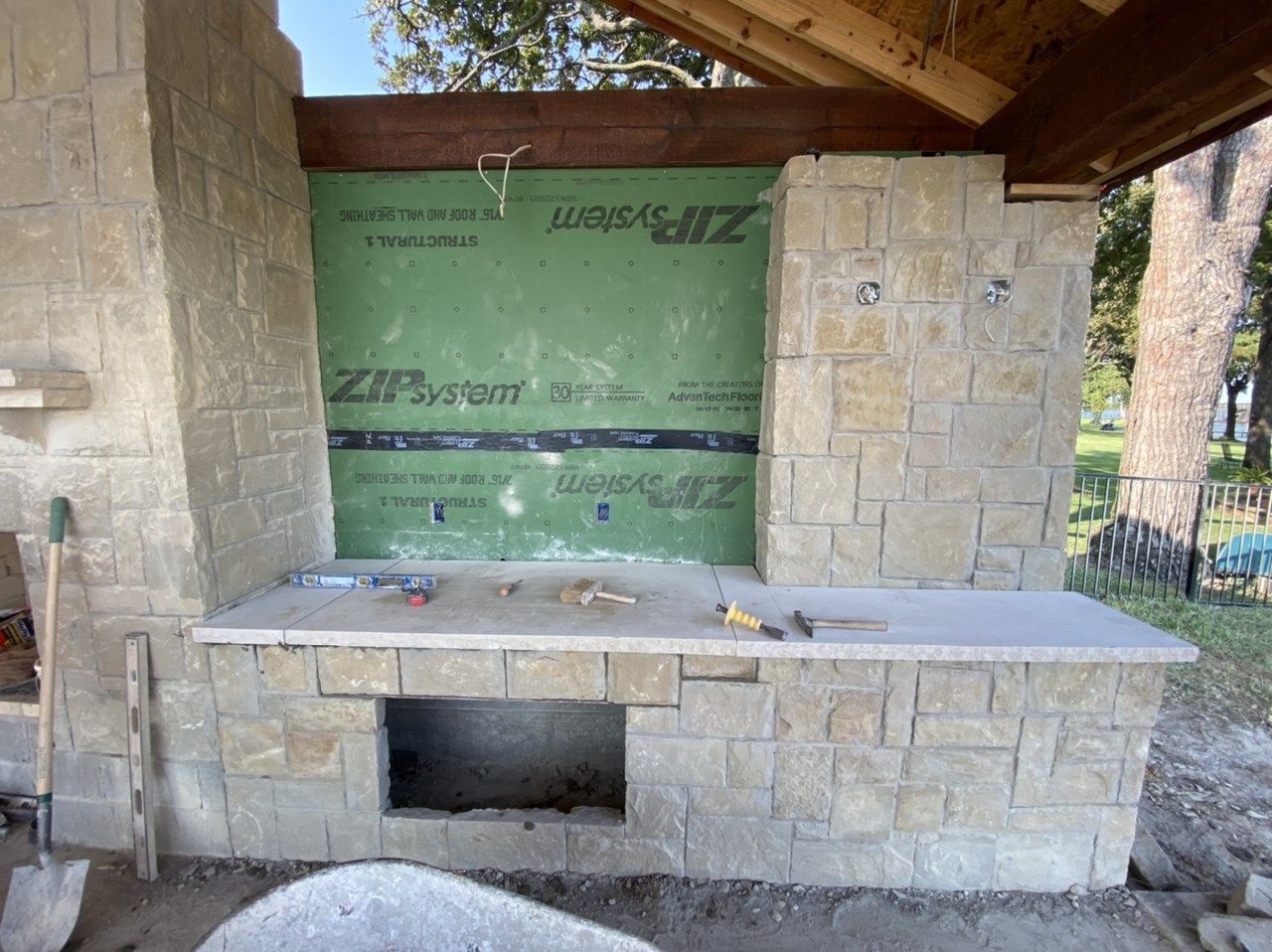 Stone fireplace and kitchen counter being set