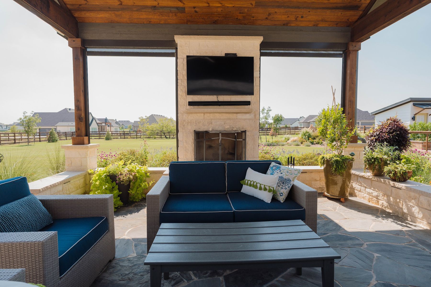 Pavilion with stone fireplace, TV and navy lounge seating, Northlake