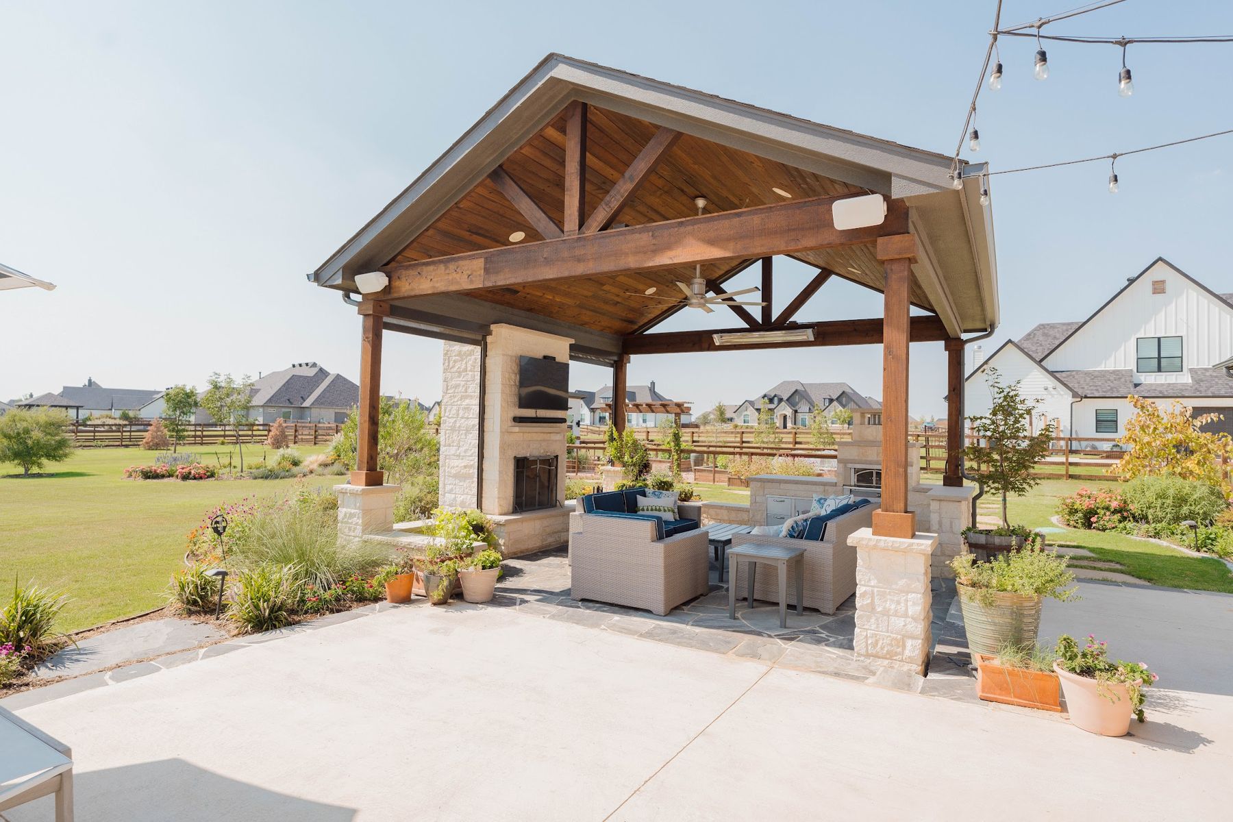 Cedar gable pavilion with stone fireplace and lounge seating, Northlake