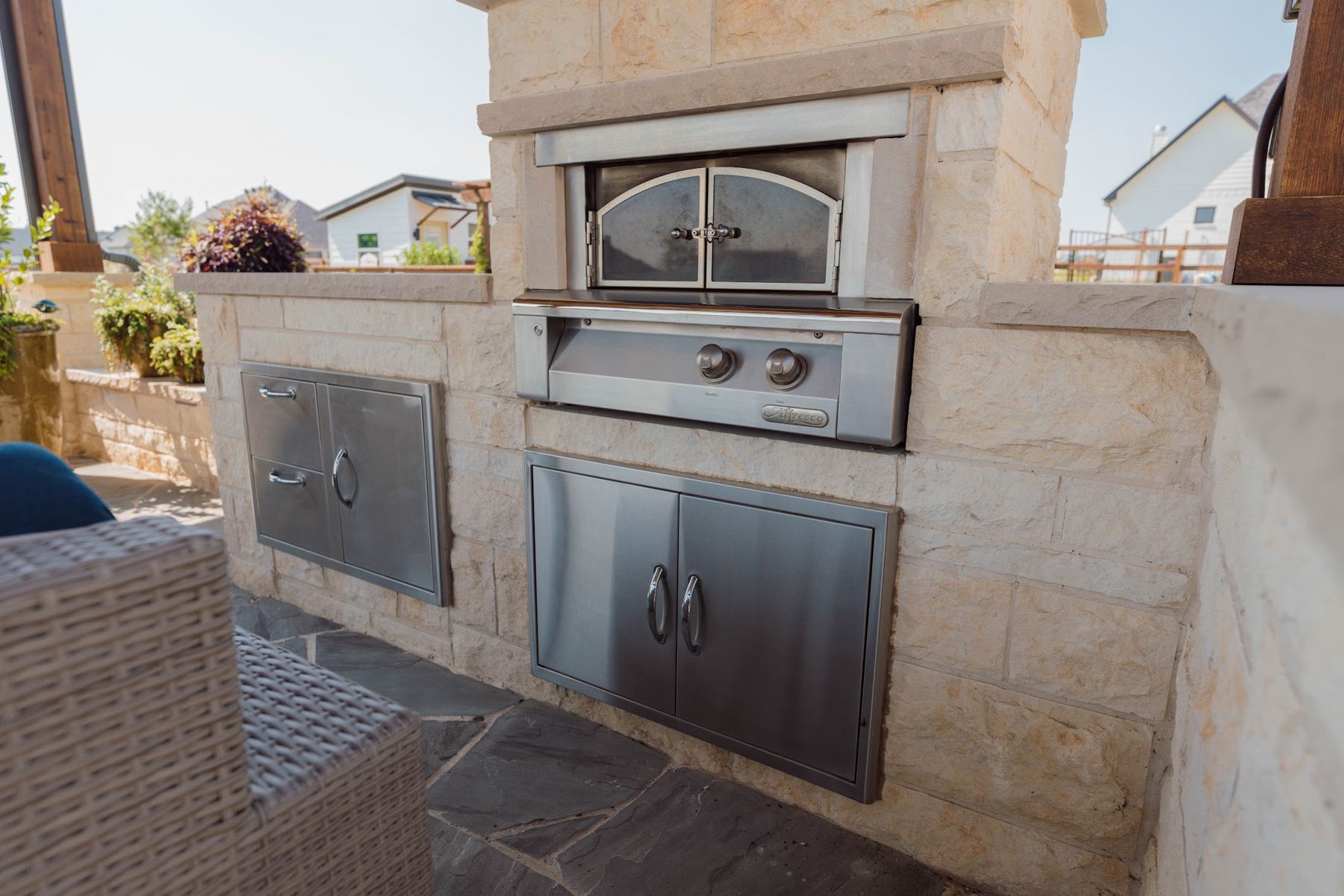 Stone kitchen with built-in pizza oven, side burner and access doors, Northlake