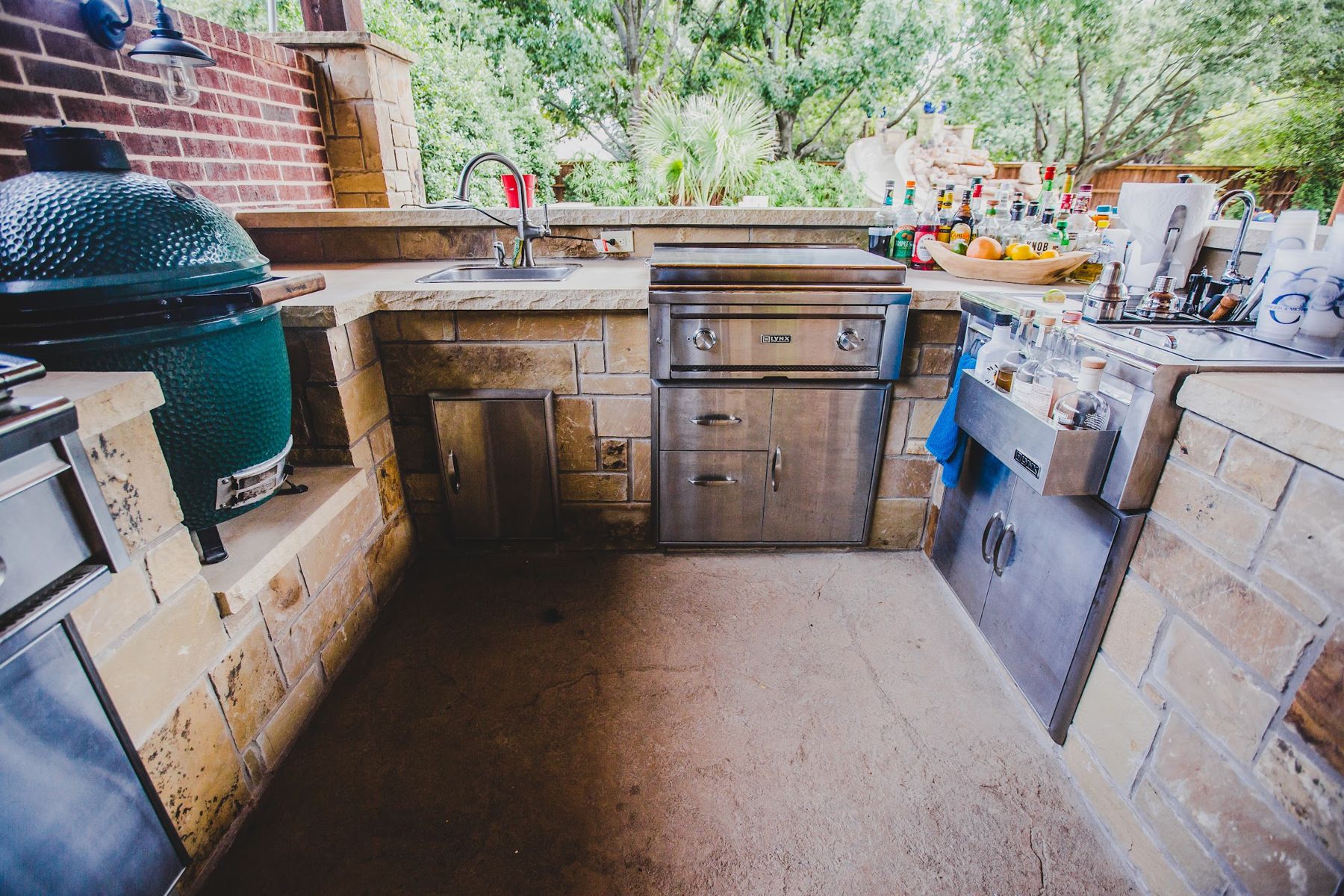 U-shaped stone outdoor kitchen with built-in grill, kamado and stainless storage, Fort Worth