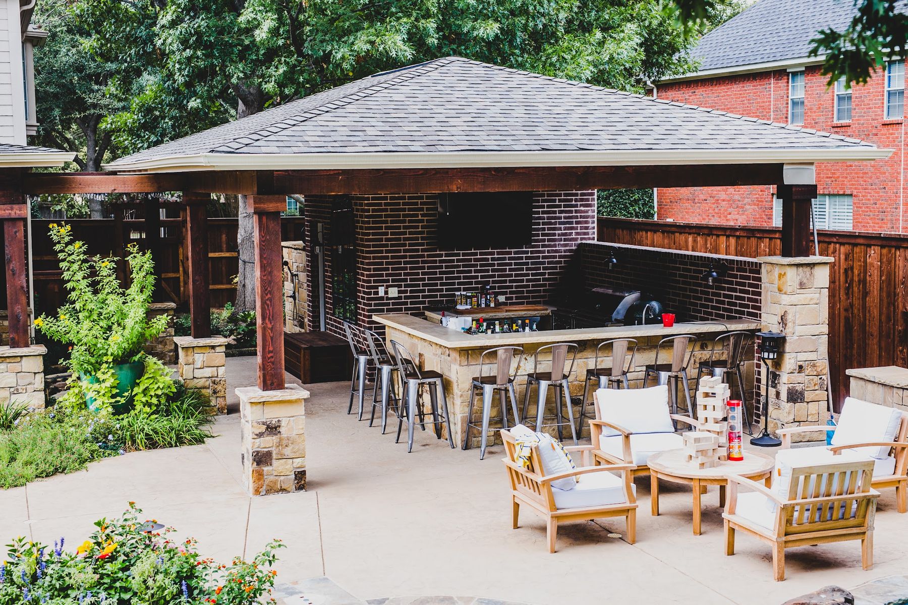 Hip-roof pavilion with stone bar, lounge chairs and garden beds, Fort Worth