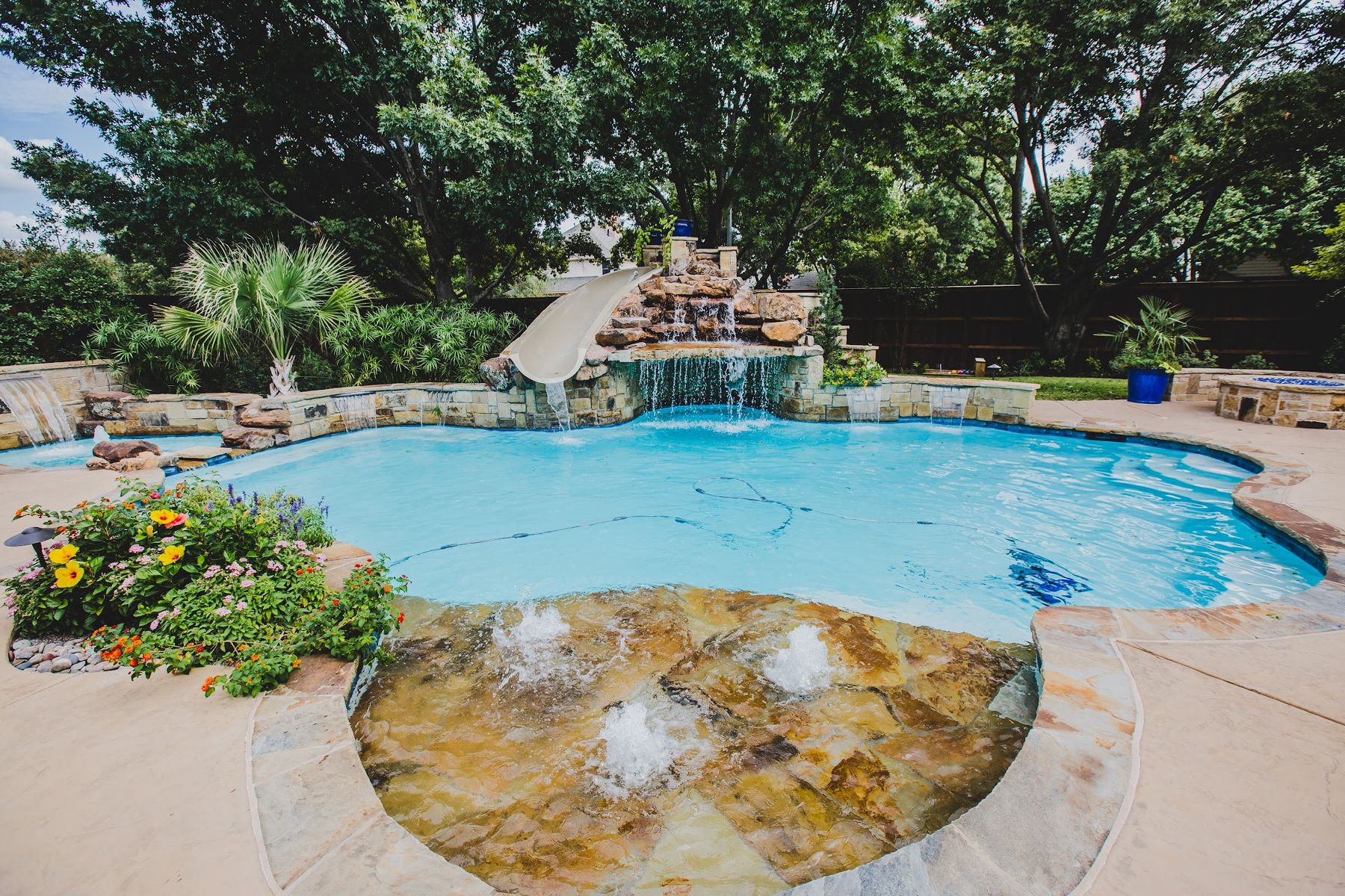 Pool with stone waterfall, slide and flagstone deck, Fort Worth